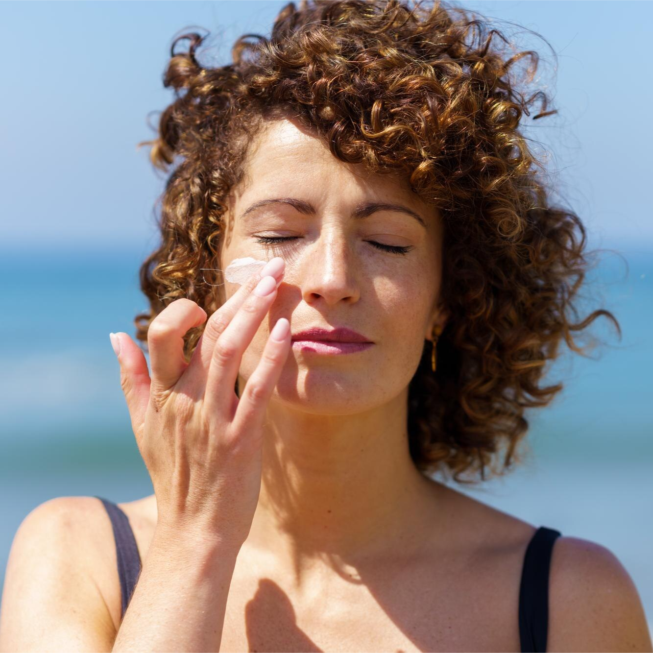 Women applying Cream Cleanser on face.