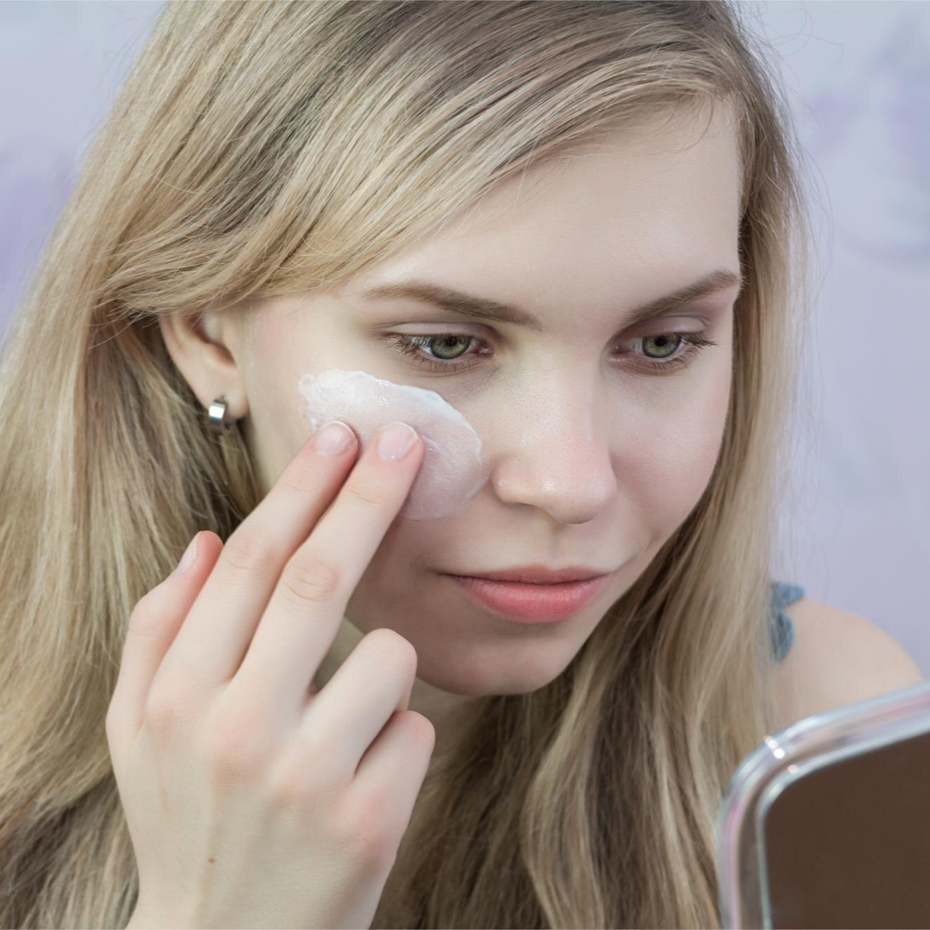 Woman applying prime skincare Daily moisturiser on face