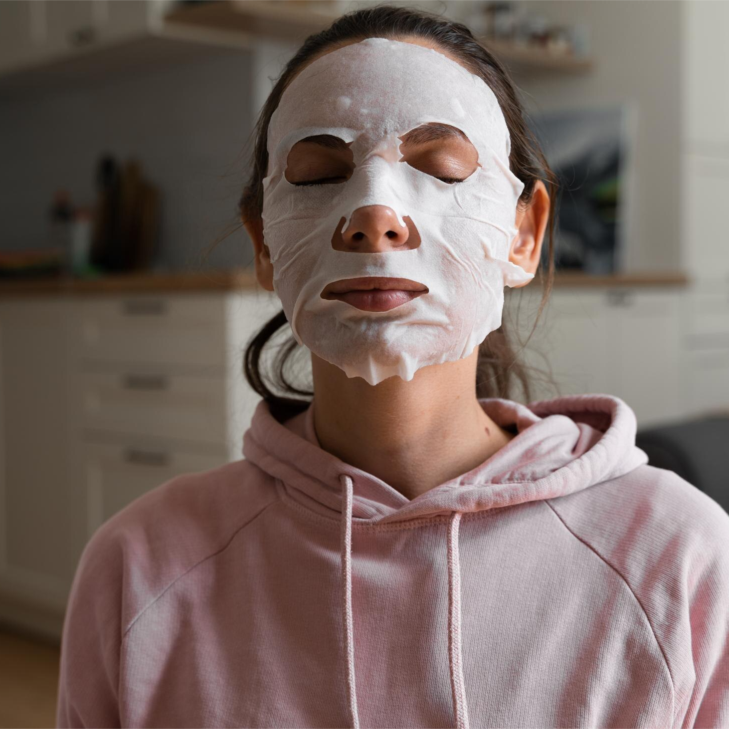 Customer using Recovery Sheet mask on face