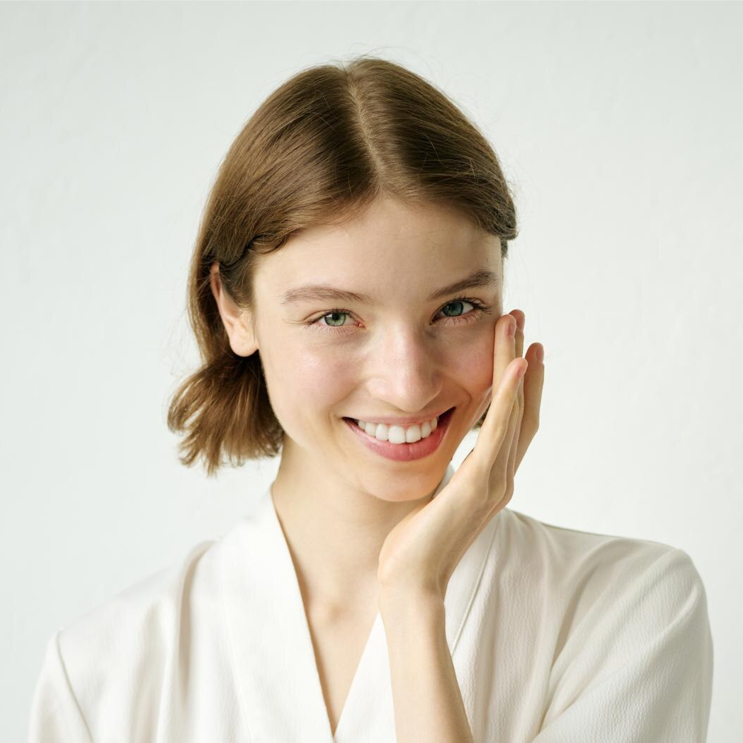 Woman applying facial cream